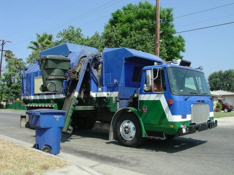 Workers sorting items for recycling and donation during a house clearance